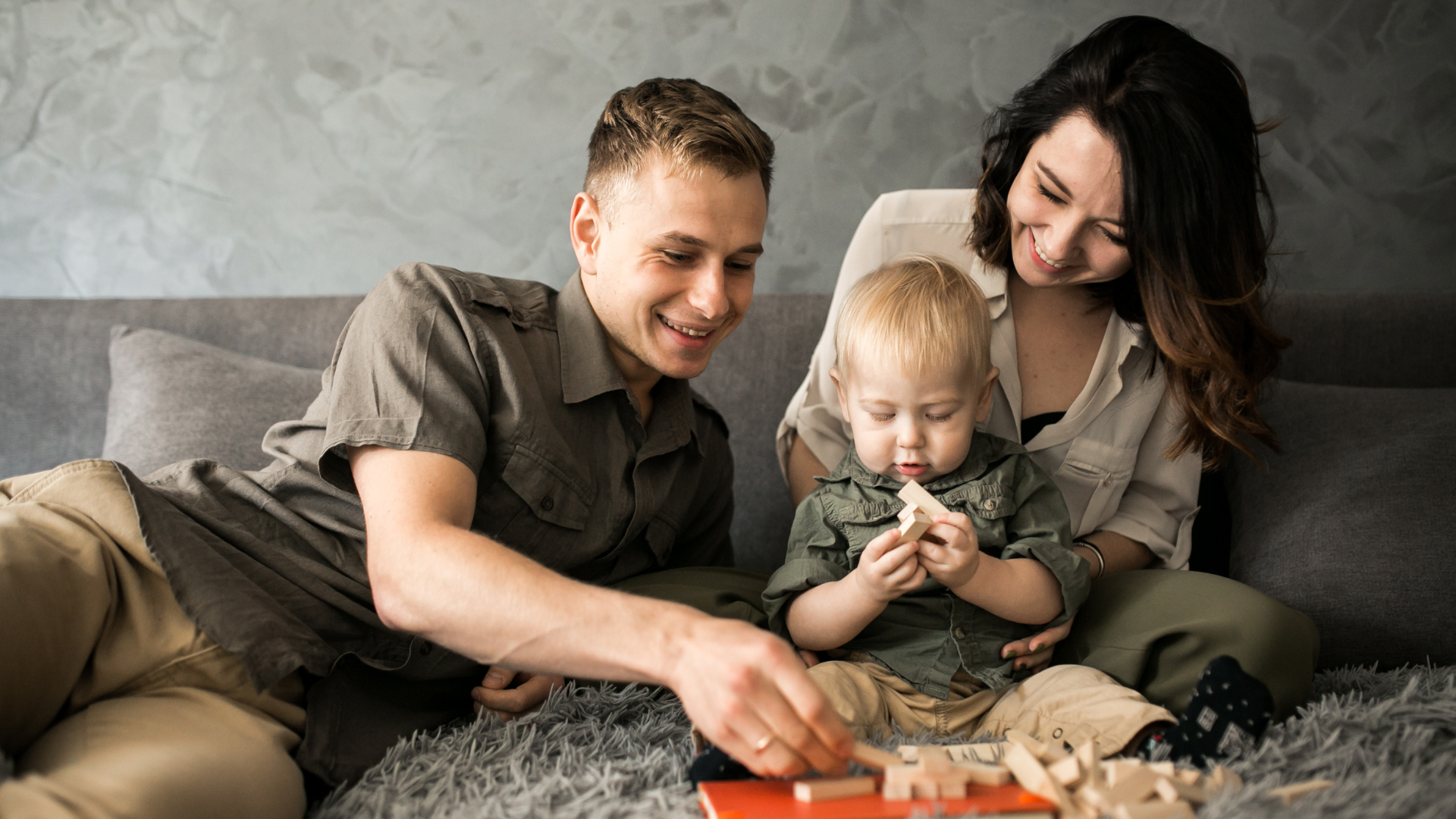 Couple with baby playing bricks ExSeed Health